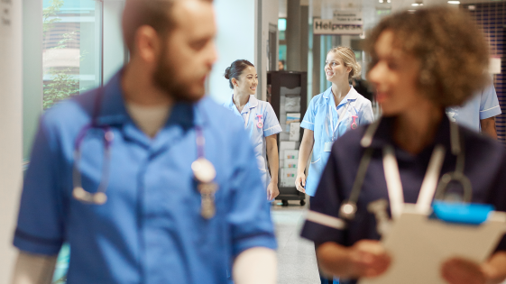 Hospital staff walking through corridor