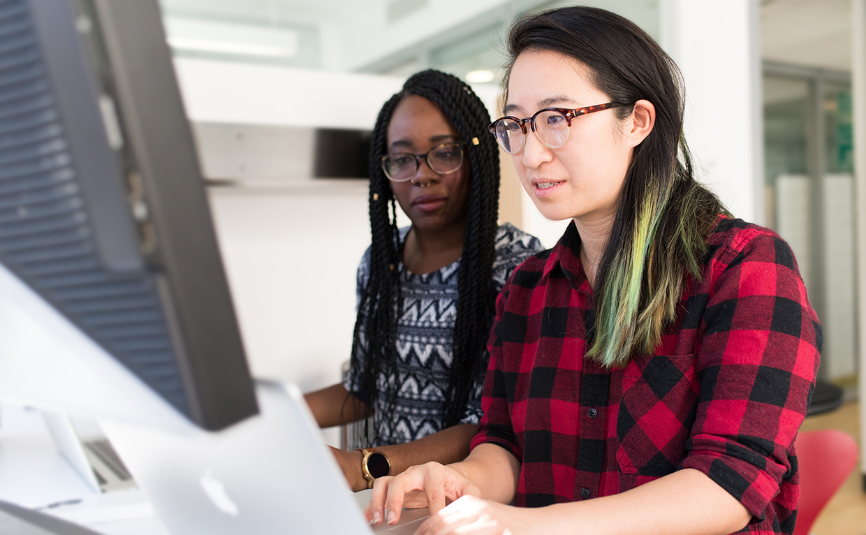 Two women working at a computer